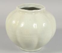 A CHINESE CELADON GLAZE OCTAGONAL LOBED JAR, the body with carved floral decoration. 20.5cm high