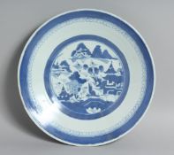 A CHINESE BLUE AND WHITE PORCELAIN DISH, the central roundel containing a landscape scene