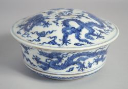 A CHINESE BLUE AND WHITE PORCELAIN BOWL AND COVER, painted with dragons amongst clouds, six-