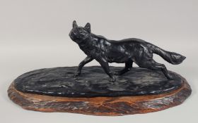 A LARGE JAPANESE BRONZE STATUE OF A FOX, on a fitted carved hardwood stand, signed to the bronze