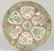 AN ISLAMIC MARKET CANTONESE FAMILLE ROSE PORCELAIN DISH, painted with panels of figures, flora and