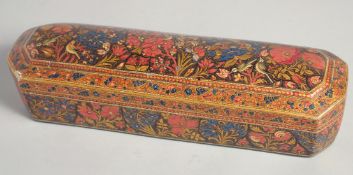 A 19TH CENTURY OTTOMAN PAPIER MACHE PEN BOX, painted with floral decoration and exotic birds, the