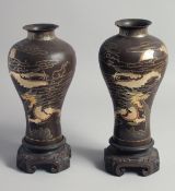 A PAIR OF JAPANESE LACQUER PAPIER MACHE VASES on hardwood stands, with gilt work decoration