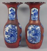 A LARGE PAIR OF JAPANESE ARITA PORCELAIN VASES, over-painted with ironstone red and gilt cross-