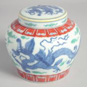 A CHINESE DOUCAI DRAGON JAR AND COVER, Tian mark to the base, 13cm high.