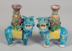 A PAIR OF CHINESE SANCAI TEMPLE LION POTTERY CANDLESTICKS, 15.5cm high