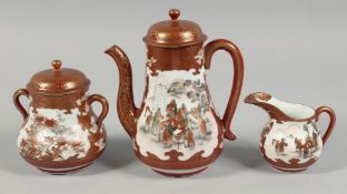 A JAPANESE KUTANI PORCELAIN THREE PIECE TEA SET, each piece painted with panels of figures and