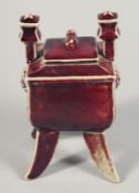 A CHINESE SQUARE FORM FLAMBE PORCELAIN INCENSE BURNER AND COVER, raised on four curving legs, the
