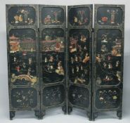 A LARGE JAPANESE FOUR PANEL LACQUERED WOOD FOLDING SCREEN, with raised hardstone and bone decoration