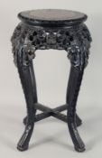 A CHINESE CARVED HARDWOOD MARBLE INSET STAND, with carved and pierced foliate frieze supported on