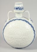 A CHINESE BLUE AND WHITE PORCELAIN MOON FLASK with twin handles and raised decoration depicting