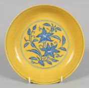 A CHINESE IMPERIAL YELLOW BLUE AND WHITE GROUND PORCELAIN DISH decorated with flora, with six-