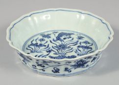 A CHINESE BLUE AND WHITE PORCELAIN PETAL FORM BOWL decorated with lotus and fish. 17.5cm diameter