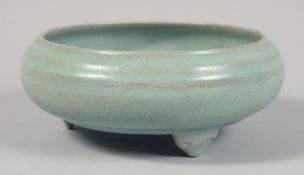 A CHINESE CELADON GLAZE PORCELAIN TRIPOD CENSER with original fitted box. Bowl diameter 17cm