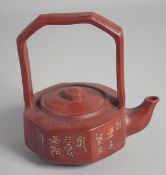 A CHINESE YIXING TEAPOT AND COVER, with long handle and calligraphy, 15cm high.