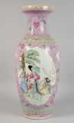 A LARGE CHINESE PINK GROUND FAMILLE ROSE PORCELAIN VASE decorated with panels of figures, mark in