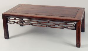 A SMALL CHINESE HARDWOOD LOW TABLE, with carved and pierced frieze on square form legs, 76cm wide,