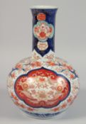 A JAPANESE IMARI PORCELAIN BULBOUS BOTTLE VASE painted with panels of foliate motifs. 30cm high