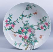 A LARGE CHINESE FAMILLE ROSE PORCELAIN PEACH DISH, painted with peach blossom and bats, with six-