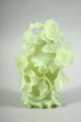 A CHINESE CARVED JADE VASE AND COVER, carved in relief with flowers and vine, 16cm high.