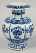 A CHINESE BLUE AND WHITE RIBBED PORCELAIN VASE, with decorative motifs to the body and six-character