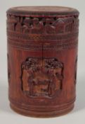 A CHINESE CARVED BAMBOO CYLINDRICAL BOX AND COVER, the sides carved with panels of figures and