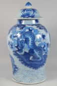 A VERY LARGE CHINESE BLUE AND WHITE PORCELAIN URN AND COVER painted with tigers against a fish scale