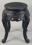 A SMALL CHINESE EBONISED HARDWOOD STAND, with carved frieze supported on four curving legs, top