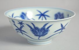 A CHINESE BLUE AND WHITE PORCELAIN BOWL, painted with large flower heads, six-character mark to