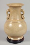 A LARGE CHINESE TWIN HANDLE CRACKLE-GLAZE VASE on a hardwood stand, with moulded drop-ring