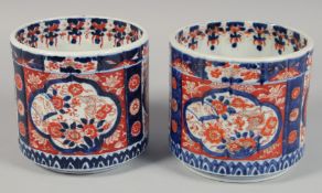 A PAIR OF JAPANESE IMARI PORCELAIN JARDINIERES painted with panels of flora. 15cm high