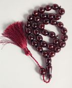 A CHERRY RED BEADED TESBIH, beads approx. 12mm