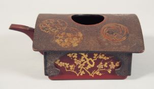 A JAPANESE SQUARE FORM LACQUERED WOOD TEAPOT with gilt decoration depicting native flora. 21cm long