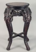 A CHINESE CARVED HARDWOOD MARBLE INSET STAND, with carved and pierced foliate frieze supported on