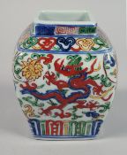 A CHINESE WUCAI PORCELAIN SQUARE FORM JAR, painted with dragons and with six-character mark to base,