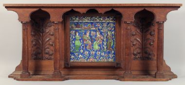 A LARGE PERSIAN QAJAR GLAZED POTTERY TILE inset within a carved oak overmantle, the tile depicting