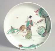 A CHINESE FAMILLE VERTE PORCELAIN DISH, painted with a female figure and deer, with red mark to