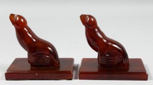 A RARE PAIR OF ART DECO BAKELITE SEAL SHAPED BOOK STANDS, base 13cm x 8.5cm