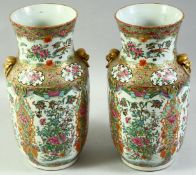 A PAIR OF CHINESE CANTON TWIN HANDLE PORCELAIN VASES, painted with panels depicting birds,