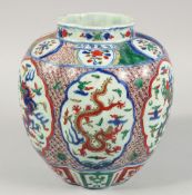 A LARGE CHINESE WUCAI PORCELAIN JAR, painted with panels of dragons, the shoulder with six-character