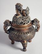 A SUPERB CHINESE BRONZE TWIN HANDLE TRIPOD CENSER AND COVER, the cover with a large foo dog finial
