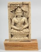 A 18TH/19TH CENTURY THAI CARVED BONE PLAQUE, depicting seated buddha, mounted to a wooden base,
