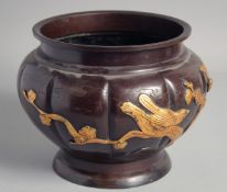 A JAPANESE BRONZE RELIEF DECORATED BOWL, with gilded birds on branches and engraved decoration, 23cm