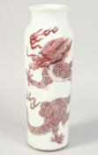 A CHINESE UNDERGLAZE RED AND WHITE PORCELAIN SLEEVE VASE painted with a dragon and stylised