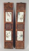 A PAIR OF DOUBLE PANELLED HARDWOOD AND PORCELAIN PLAQUES, the porcelain panels painted with birds