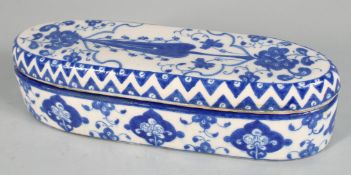 A LARGE TURKISH IZNIK BLUE AND WHITE GLAZED POTTERY PEN BOX, decorated with foliate motifs, 30.5cm