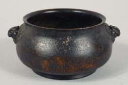 A CHINESE BRONZE TWIN HANDLE CENSER, with lion dog form handles, nine character mark to base, 12cm