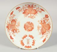 A CHINESE CORAL RED AND WHITE PORCELAIN PLATE, painted with pomegranate and bats, the base with