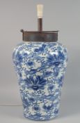 A LARGE CHINESE BLUE AND WHITE PORCELAIN LAMP VASE decorated with foliate design, drilled for