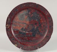 A LARGE 17th CENTURY RED LACQUERED CHARGER depicting a male figure and a seated female musician.